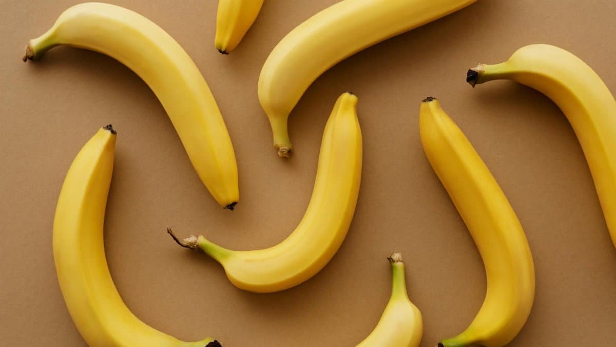 Top view of ripe bananas arranged on a brown background, perfect for healthy eating concepts.