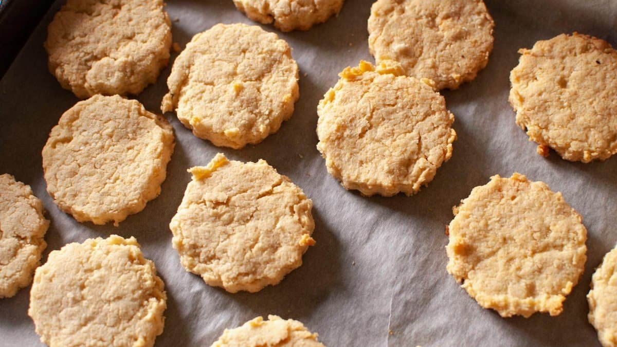 Close-up of golden homemade biscuits freshly baked on a parchment-lined tray.