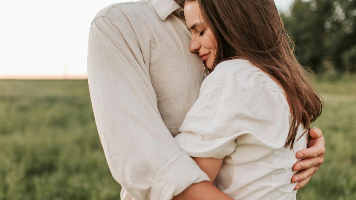 A romantic embrace between a couple outdoors at sunset, showcasing love and connection.
