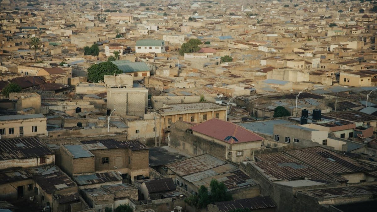 A sprawling aerial cityscape showcasing densely packed urban architecture in a neutral tone.