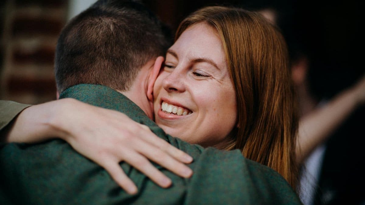 A woman joyfully embracing a man, expressing happiness and warmth.
