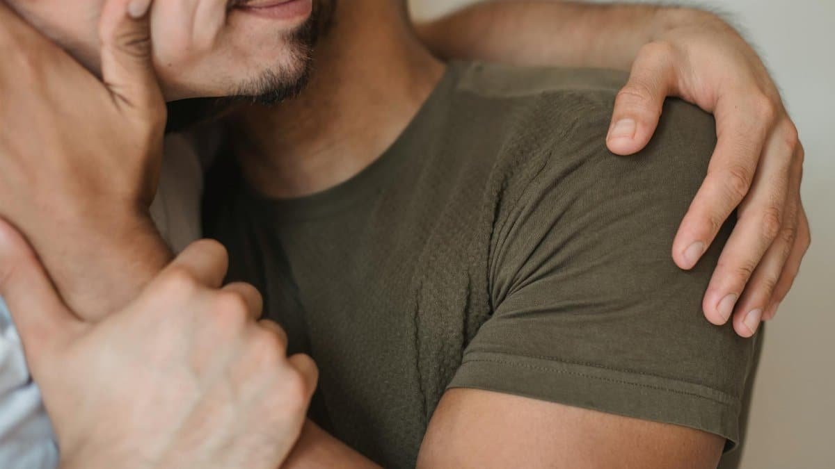 A heartfelt close-up of two men embracing, symbolizing love and connection.