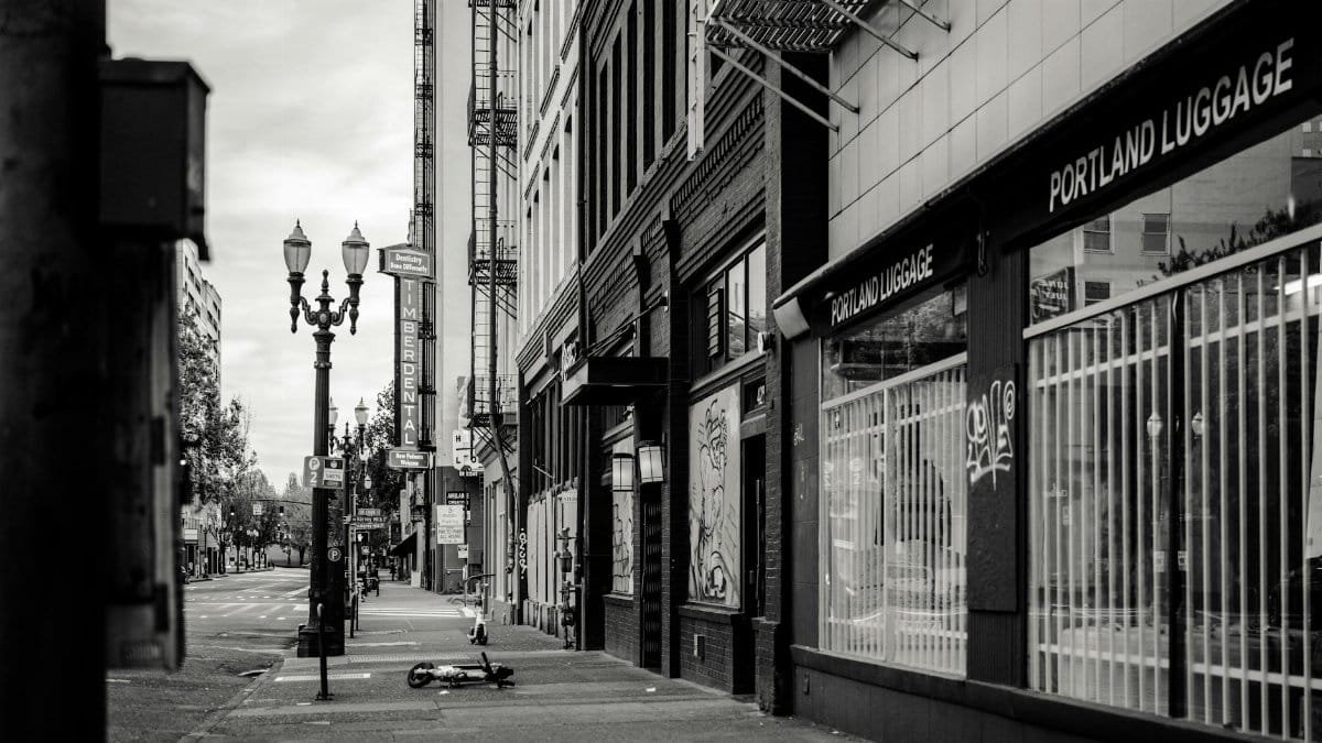 Black and white view of a tranquil street in Portland, Oregon, featuring urban architecture.