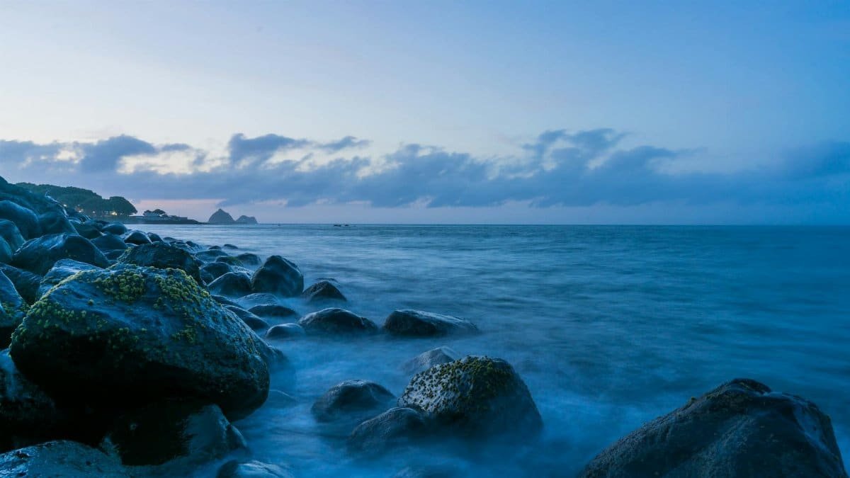Peaceful long exposure shot of rocks and ocean at New Plymouth, New Zealand.