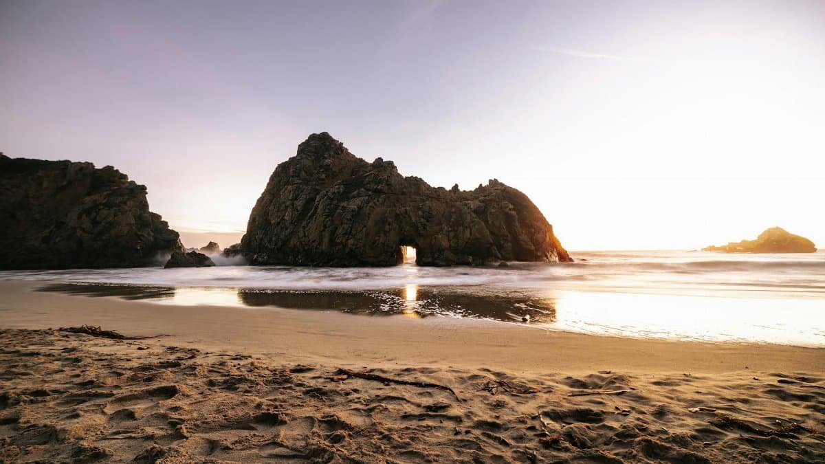 Breathtaking sunset at Pfeiffer Beach highlighting unique rock formations and serene ocean views.