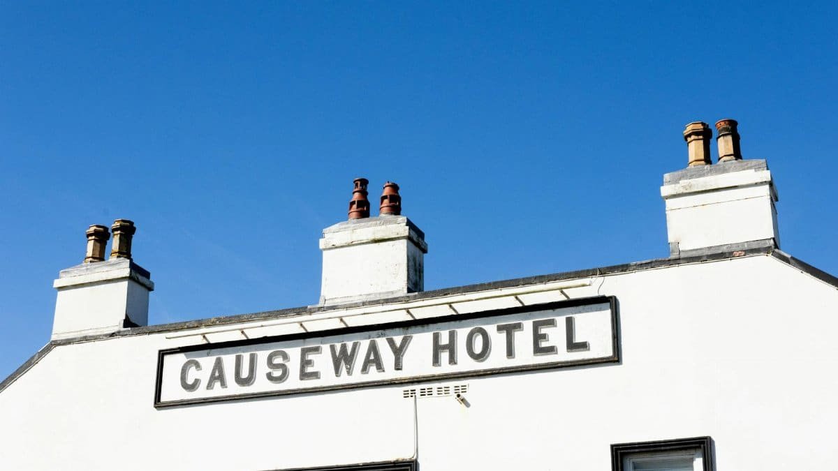 A vibrant capture of Causeway Hotel in Northern Ireland, featuring a clear blue sky.