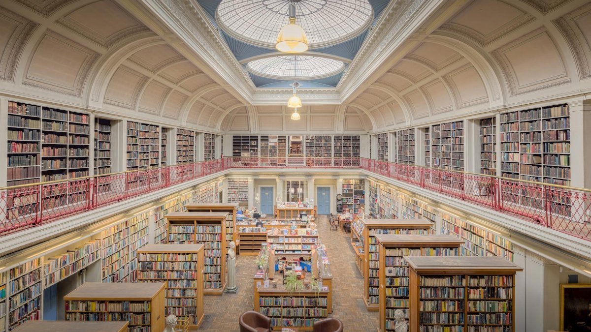 Beautiful interior of a historic library in England with bookshelves and dome ceiling.