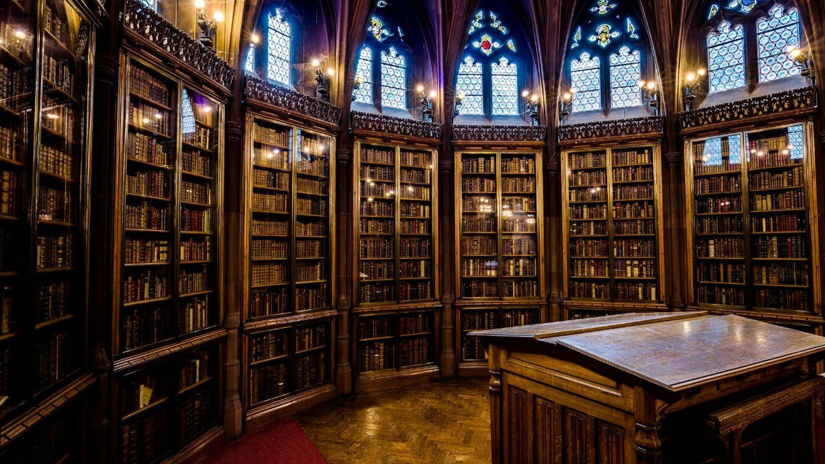 Intricate gothic architecture in a historic library room filled with bookshelves in England.