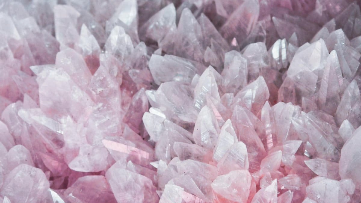 A detailed close-up of rose quartz crystals showcasing their pink hues and translucent nature.