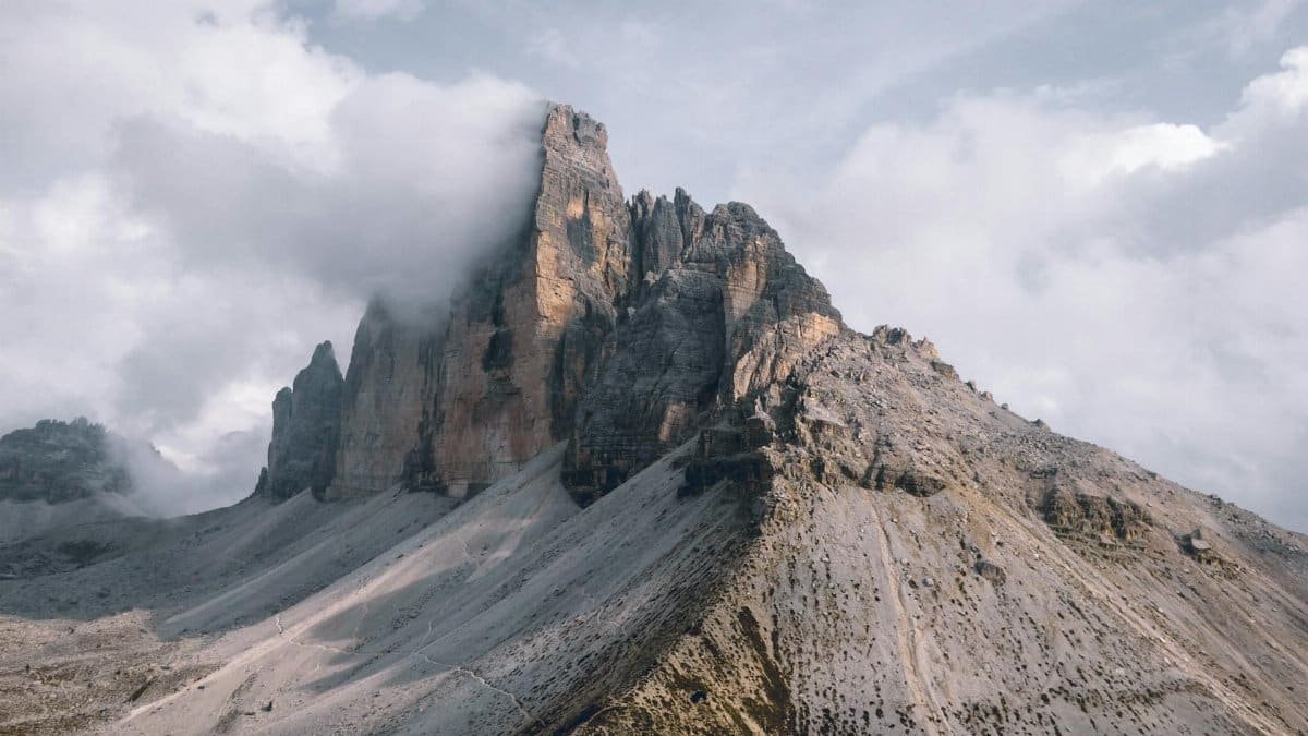 Majestic mountain peaks shrouded in clouds in a tranquil natural setting, perfect for nature enthusiasts.