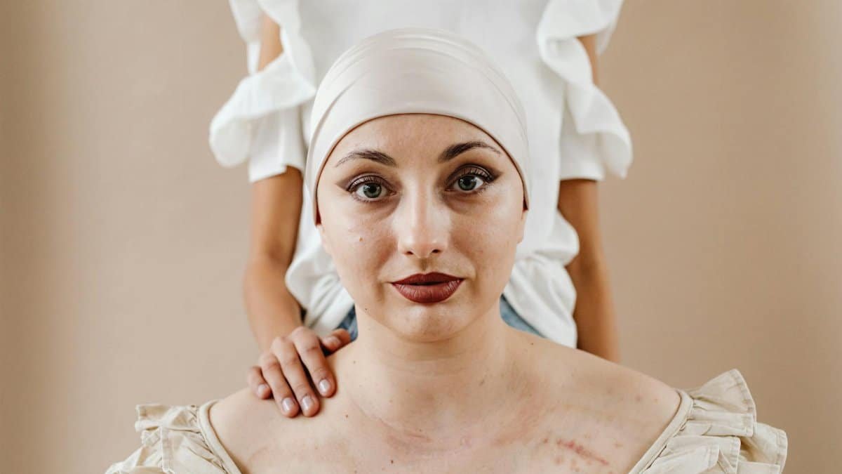 Intimate portrait of a courageous cancer survivor supported by a friend, highlighting strength and resilience.