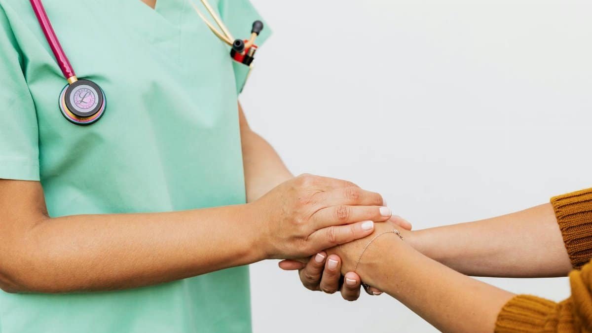 Close-up of a doctor holding a patient's hands, symbolizing trust and empathy in healthcare.