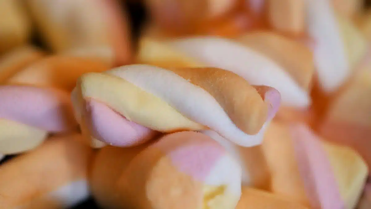 Close-up of colorful twisted marshmallow candies, perfect for sweet cravings.