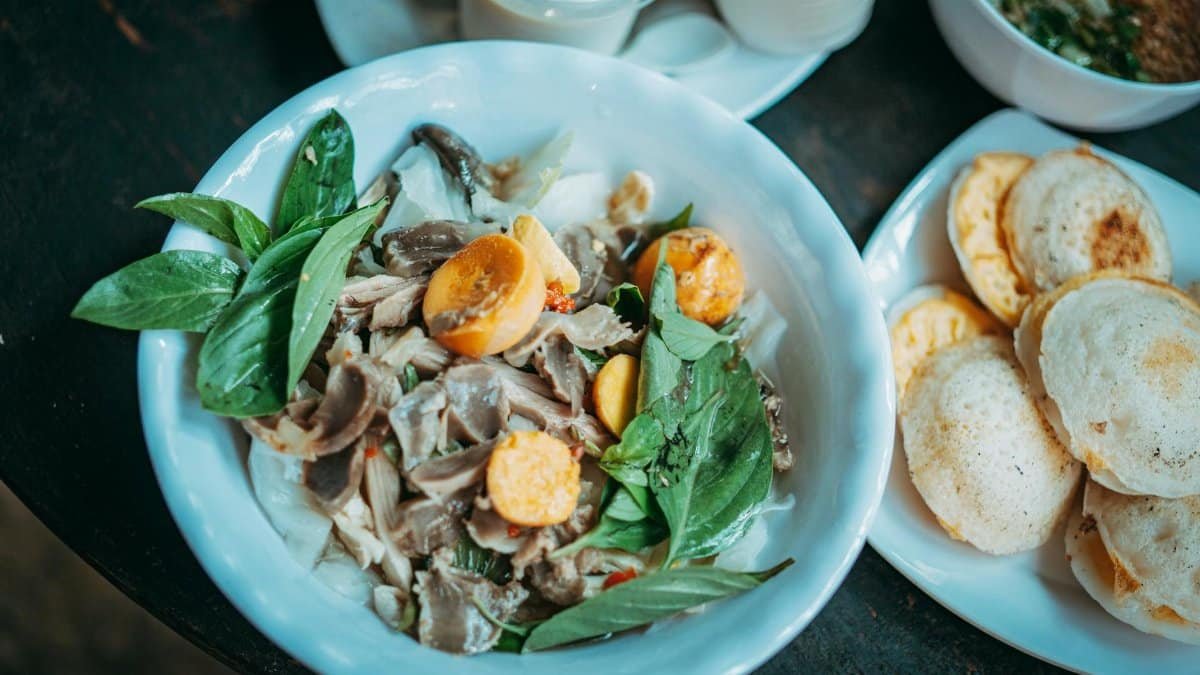 A flavorful beef dish with basil and vegetables served with side dishes, perfect for food photography.
