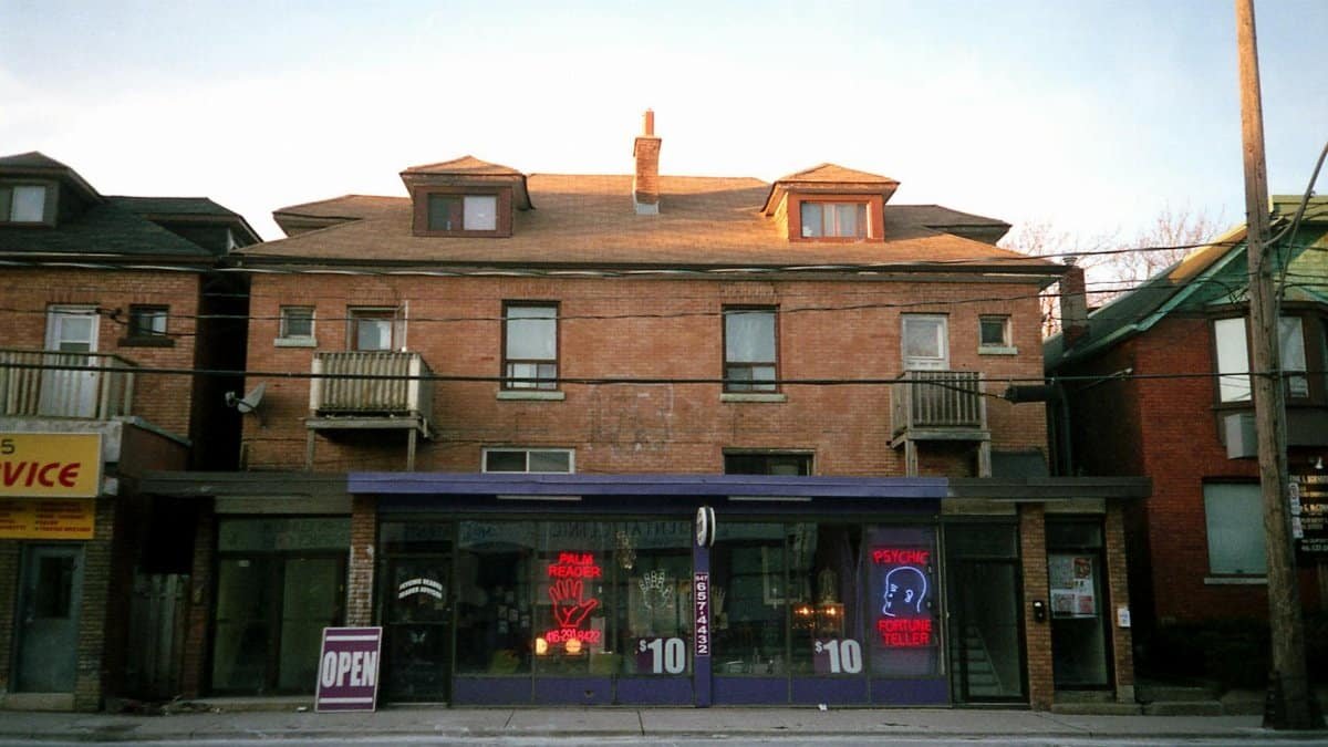 Brick building with a psychic shop in Toronto, Canada, showcasing urban charm.
