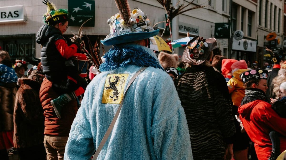 Lively street parade with people in vibrant costumes celebrating a traditional festival.