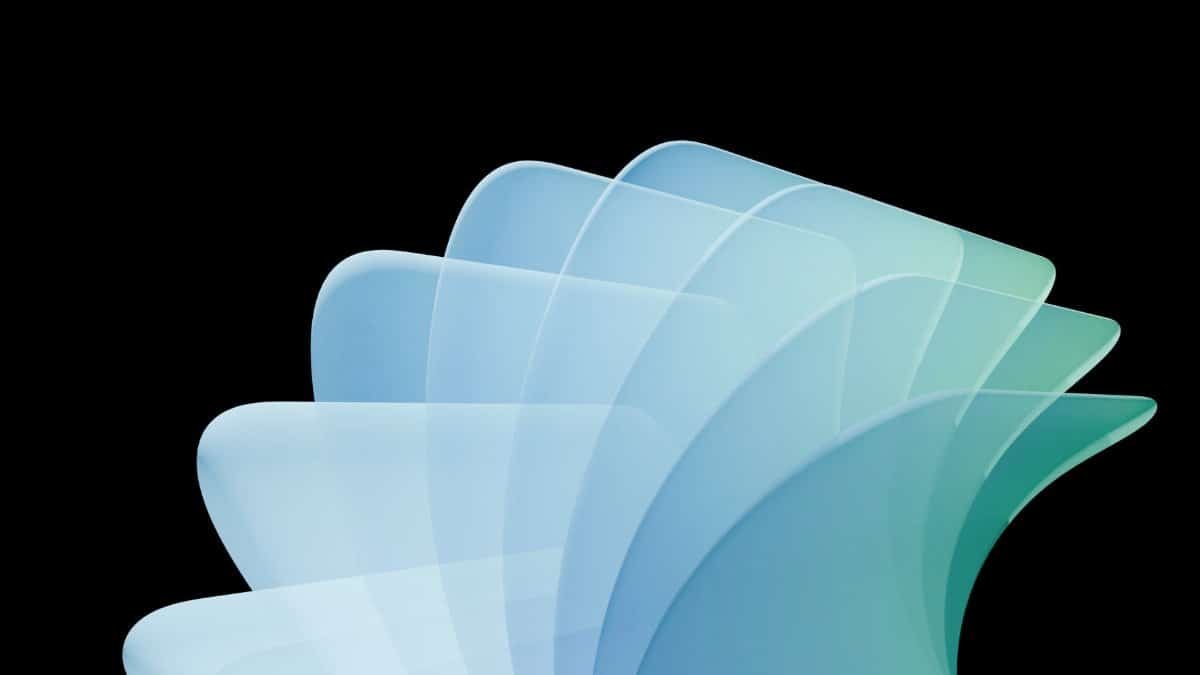 Stylized abstract design with organic shapes in blue and green on a black background.