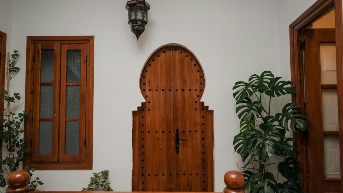 Cozy Moroccan interior featuring a distinct wooden door and lush plants.