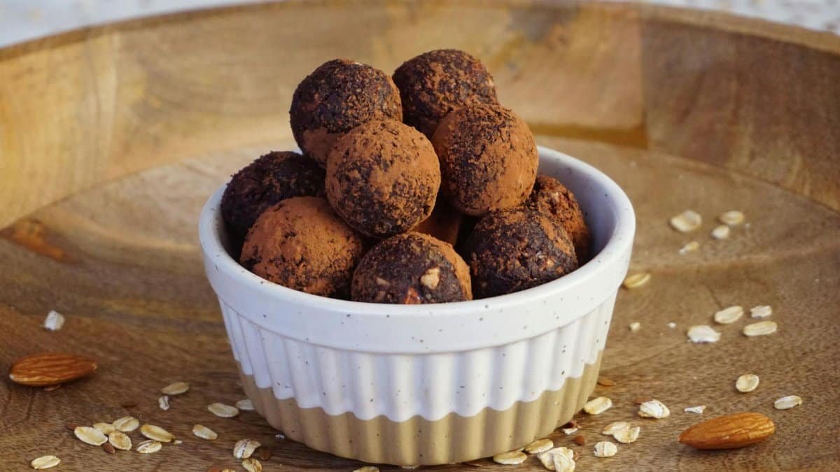 A bowl of homemade vegan chocolate energy bites made with natural ingredients for a guilt-free snack.