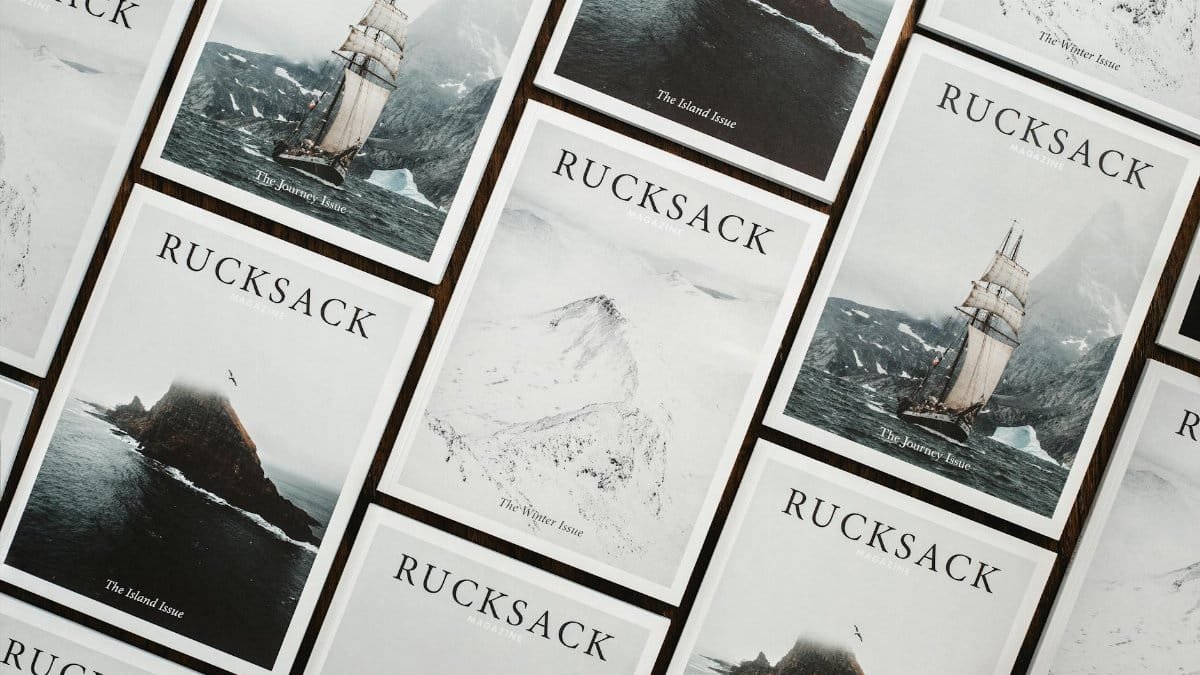 A flat lay of Rucksack magazine issues with nautical exploration themes, featuring ships and snowy landscapes.