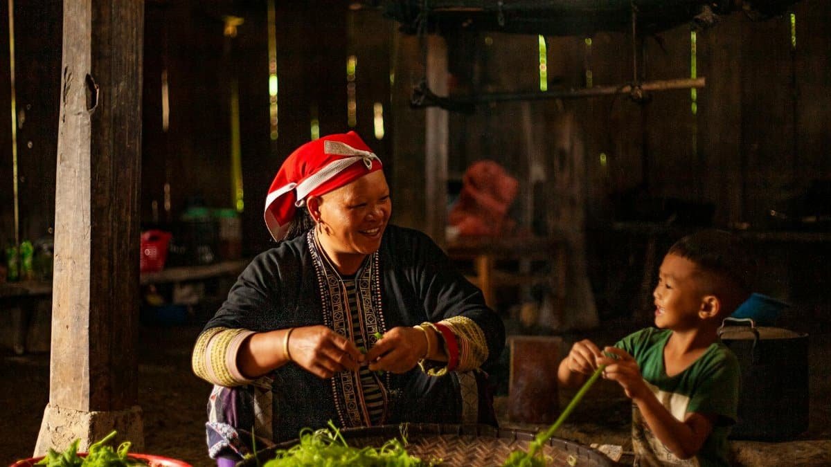 A joyful scene of a mother and son preparing vegetables together in a cozy home setting.