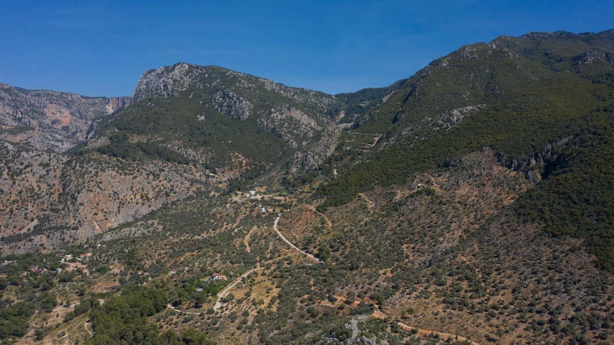Breathtaking aerial shot of a rugged mountain landscape during a clear day.