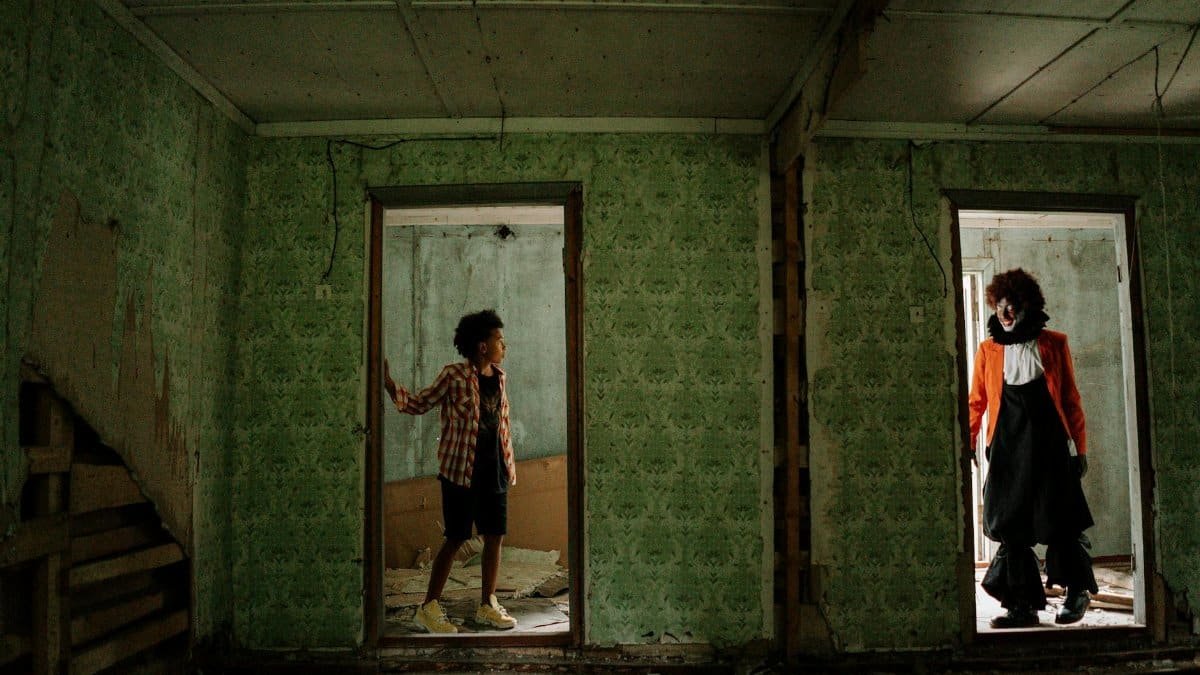 A child encounters a clown in a hauntingly abandoned building, creating a chilling atmosphere.
