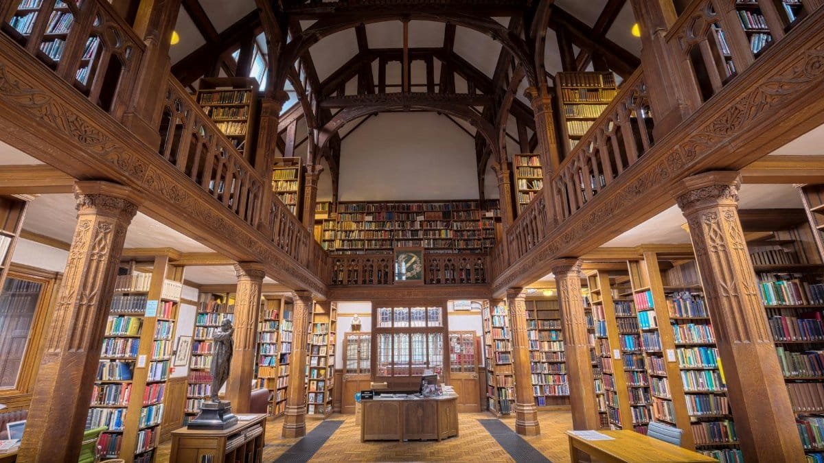 Beautiful interior view of Gladstone's Library, showcasing its wooden architecture and extensive book collection.