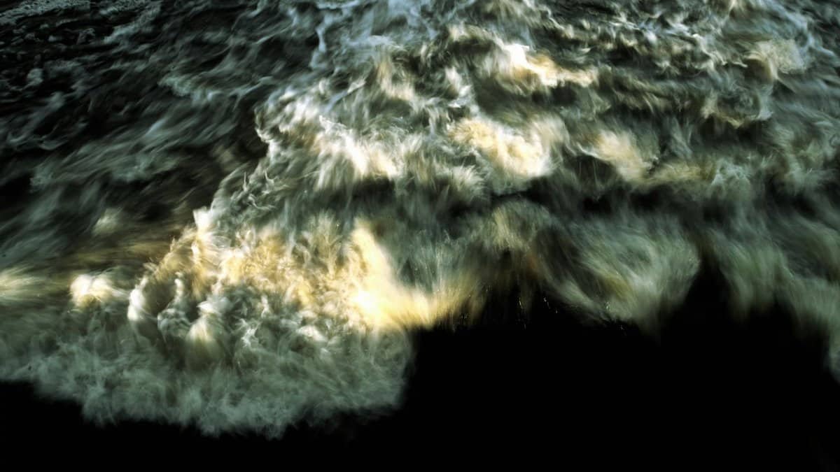 Captivating motion capture of ocean waves crashing, creating a dynamic and abstract water pattern.