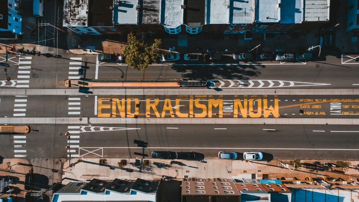 A powerful aerial shot of the 'End Racism Now' mural painted on a street in Philadelphia, promoting racial equality.