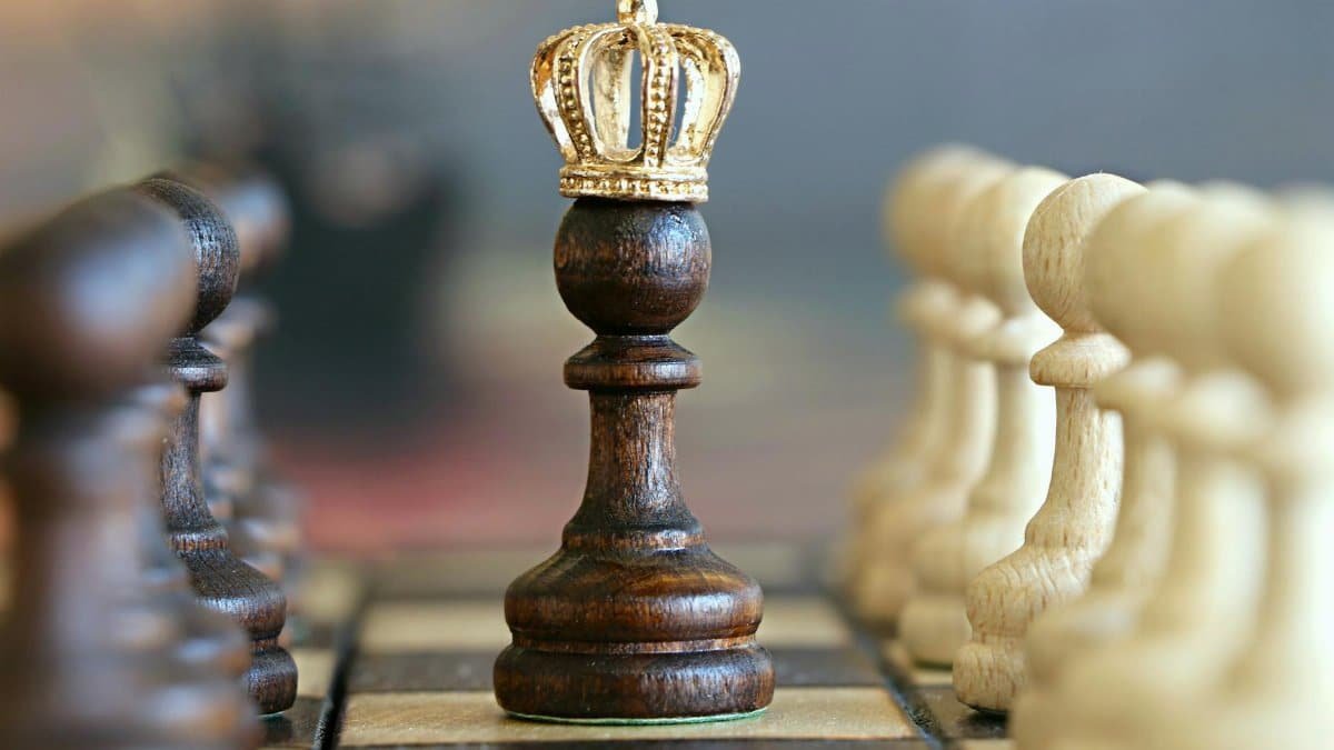A brown pawn with a crown stands prominently on a chessboard, symbolizing strategic play.