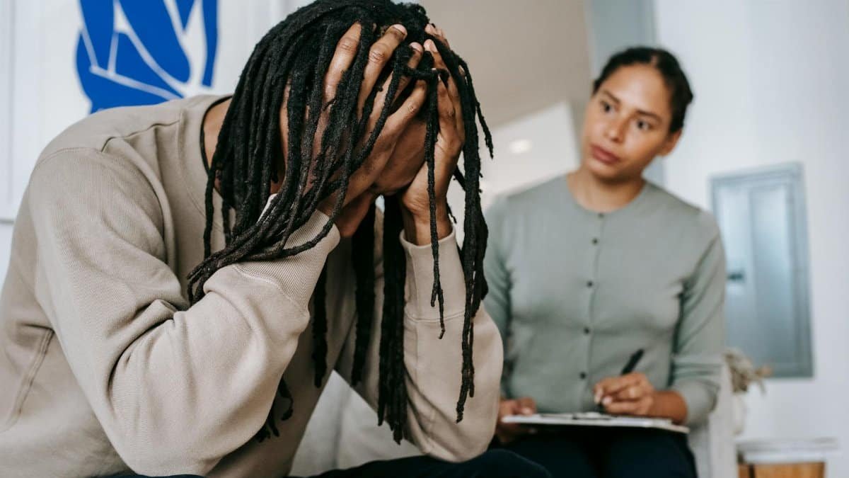A young couple in a serious indoor discussion, dealing with relationship issues and emotions.