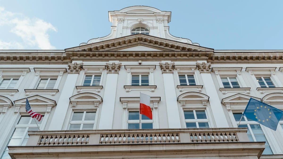 A classic architectural facade with multiple flags, showcasing international representation.