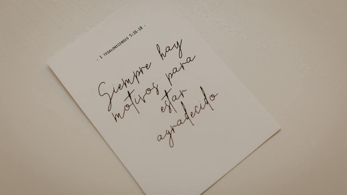 Minimalist photo of an inspirational calligraphy note on white paper.