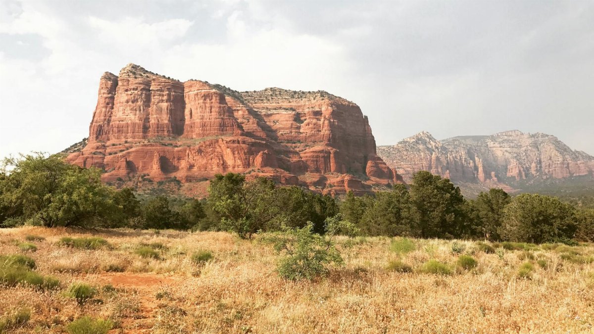 Explore the stunning red rock formations of Sedona, Arizona under the bright summer sky.