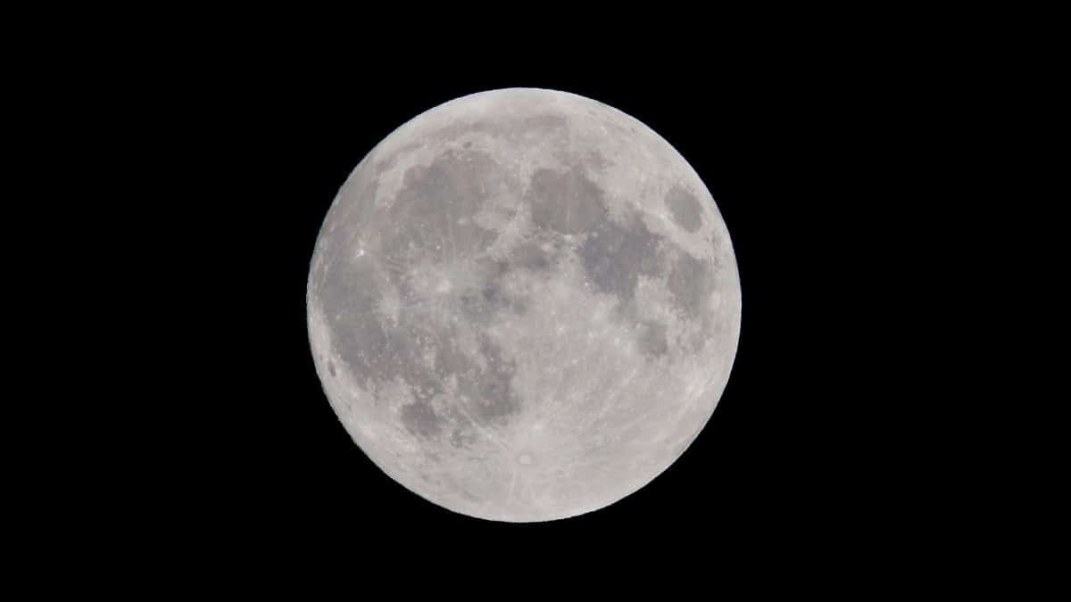 Stunning full moon against a dark night sky, showcasing captivating lunar details.