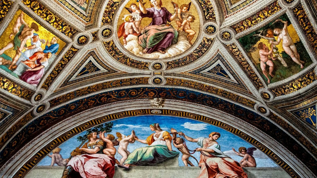 Ornate frescoed ceiling in Vatican City showcasing religious renaissance art with vibrant mosaics.