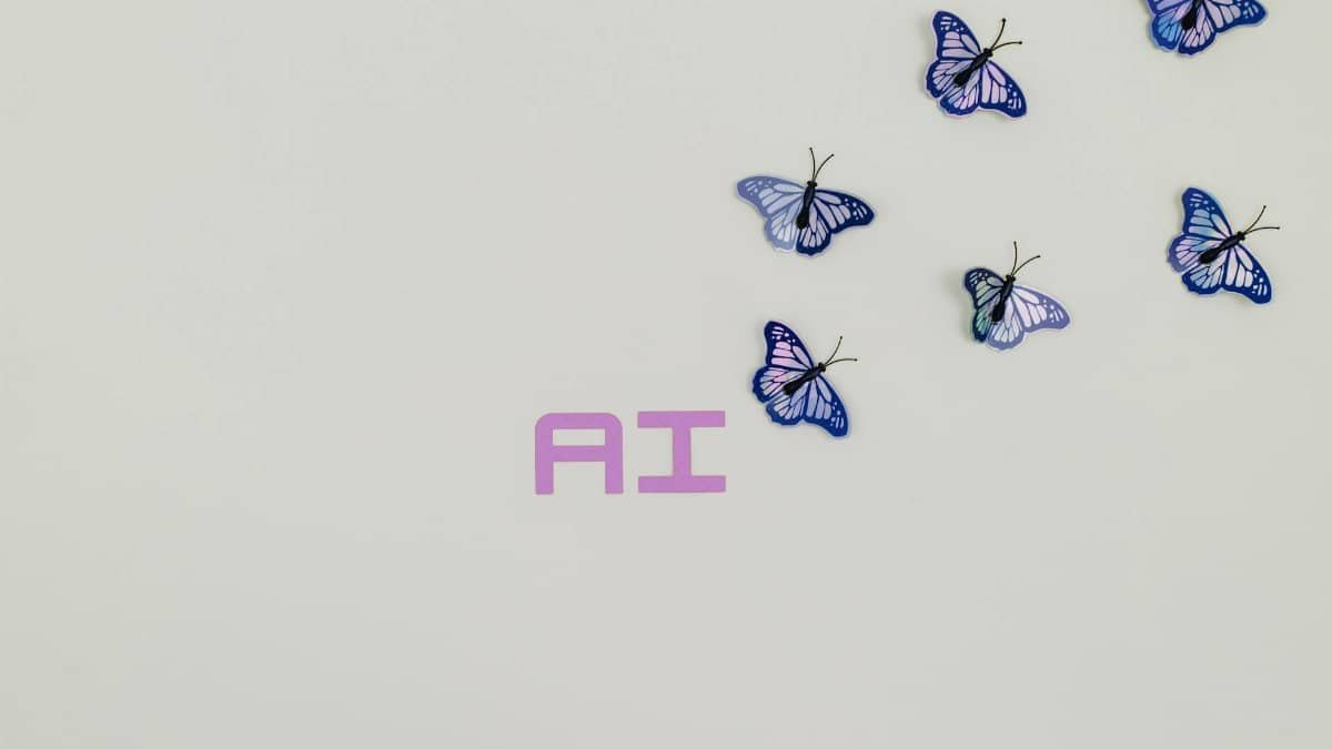 A creative image of butterflies flying over the word 'AI' on a soft pastel background, symbolizing innovation.