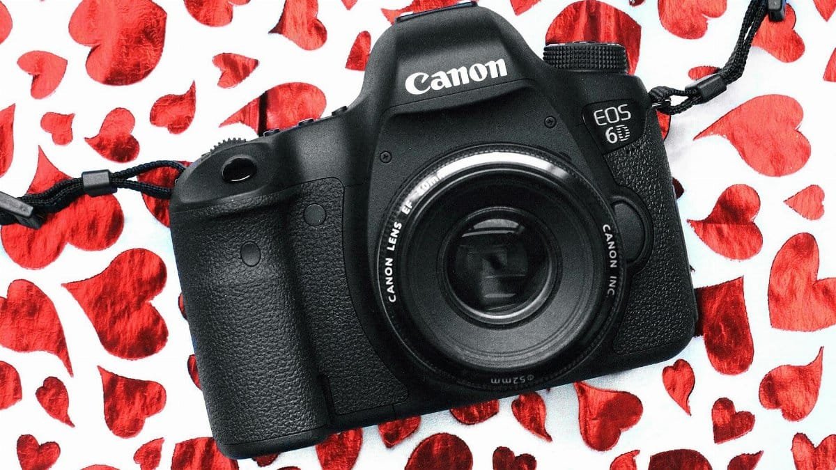 A classic vintage camera on a heart-themed Valentine's Day background, perfect for photography enthusiasts.