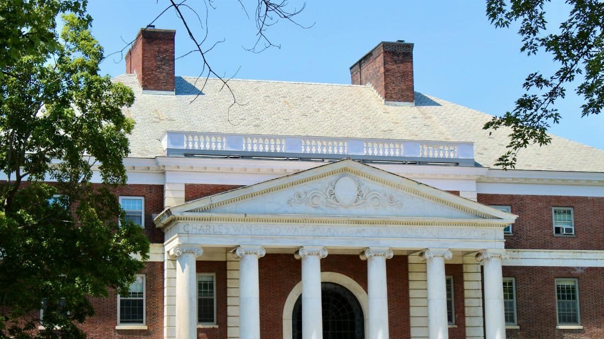 A classic brick university campus building with columns in Burlington, Vermont.