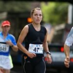 Competitive runners focused during a marathon in Wrocław city streets.