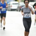 Focused marathon runners competing in a street race, showcasing athleticism and endurance.