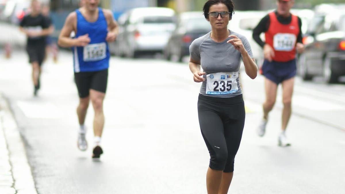 Focused marathon runners competing in a street race, showcasing athleticism and endurance.