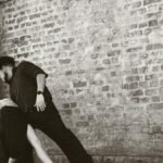 Captivating tango dancers performing in front of a brick wall in Buenos Aires, Argentina.