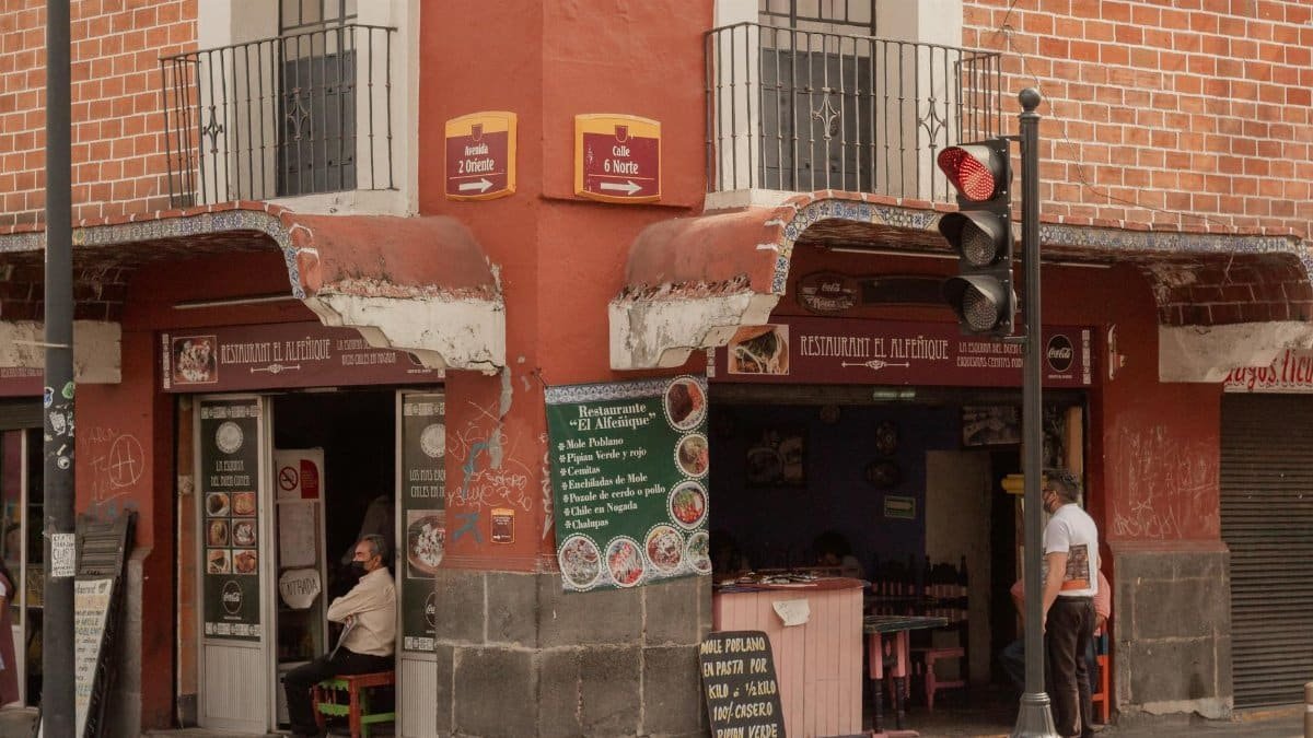 Charming urban corner with a traditional restaurant in Puebla, Mexico, capturing local life.