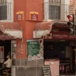 Charming urban corner with a traditional restaurant in Puebla, Mexico, capturing local life.