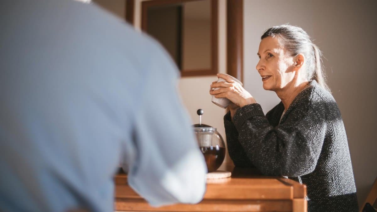 Cheerful senior couple enjoying coffee together in a cozy home setting.