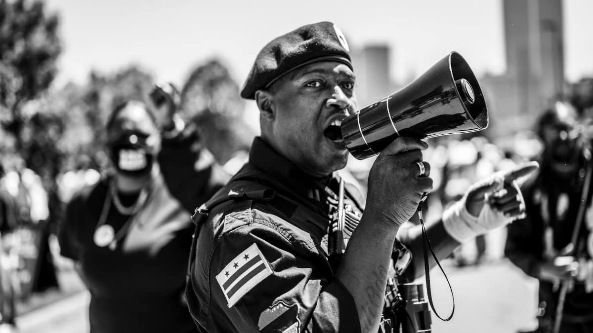 A vivid black and white depiction of a passionate protestor with a megaphone in Tulsa, Oklahoma.