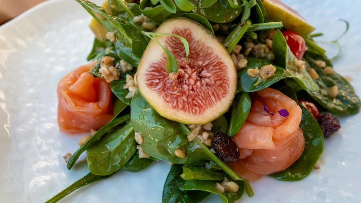 Colorful salad with figs, smoked salmon, and fresh greens, perfect for a healthy meal.