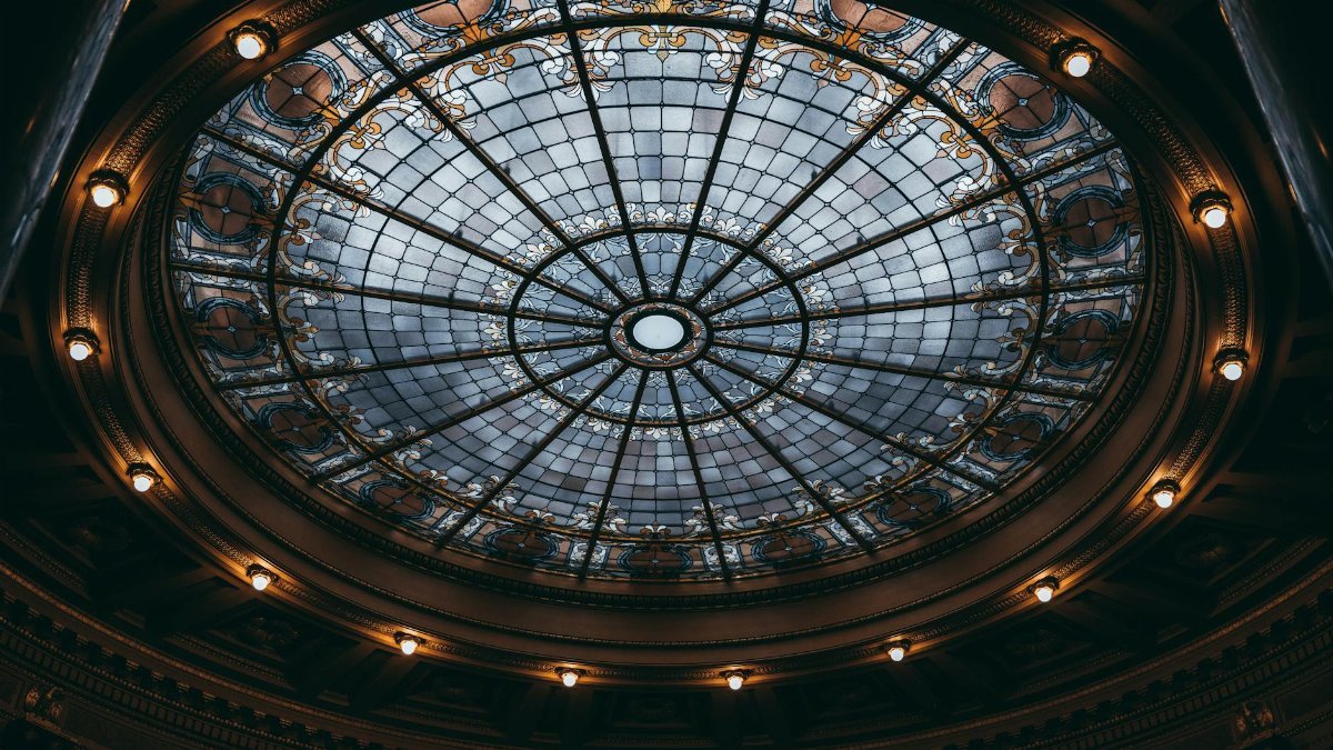 Elegant baroque glass dome illuminated in Madison, Wisconsin's State Capitol building.